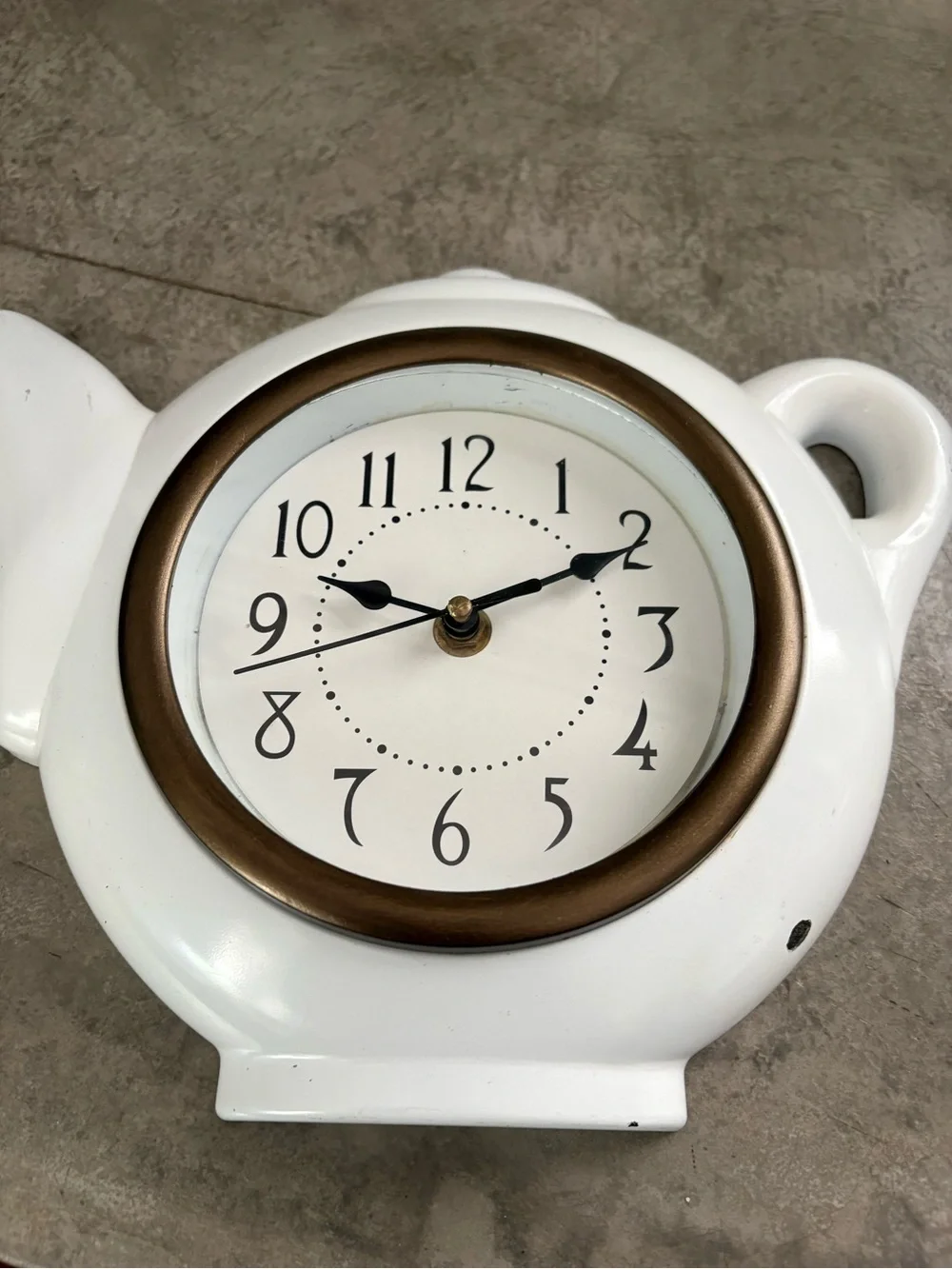 vintage teapot clock styled with a glossy white finish to look like ceramic.